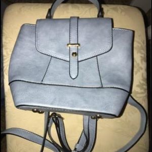 Color: blue. Backpack handbag. Adjustable straps. Never been used.